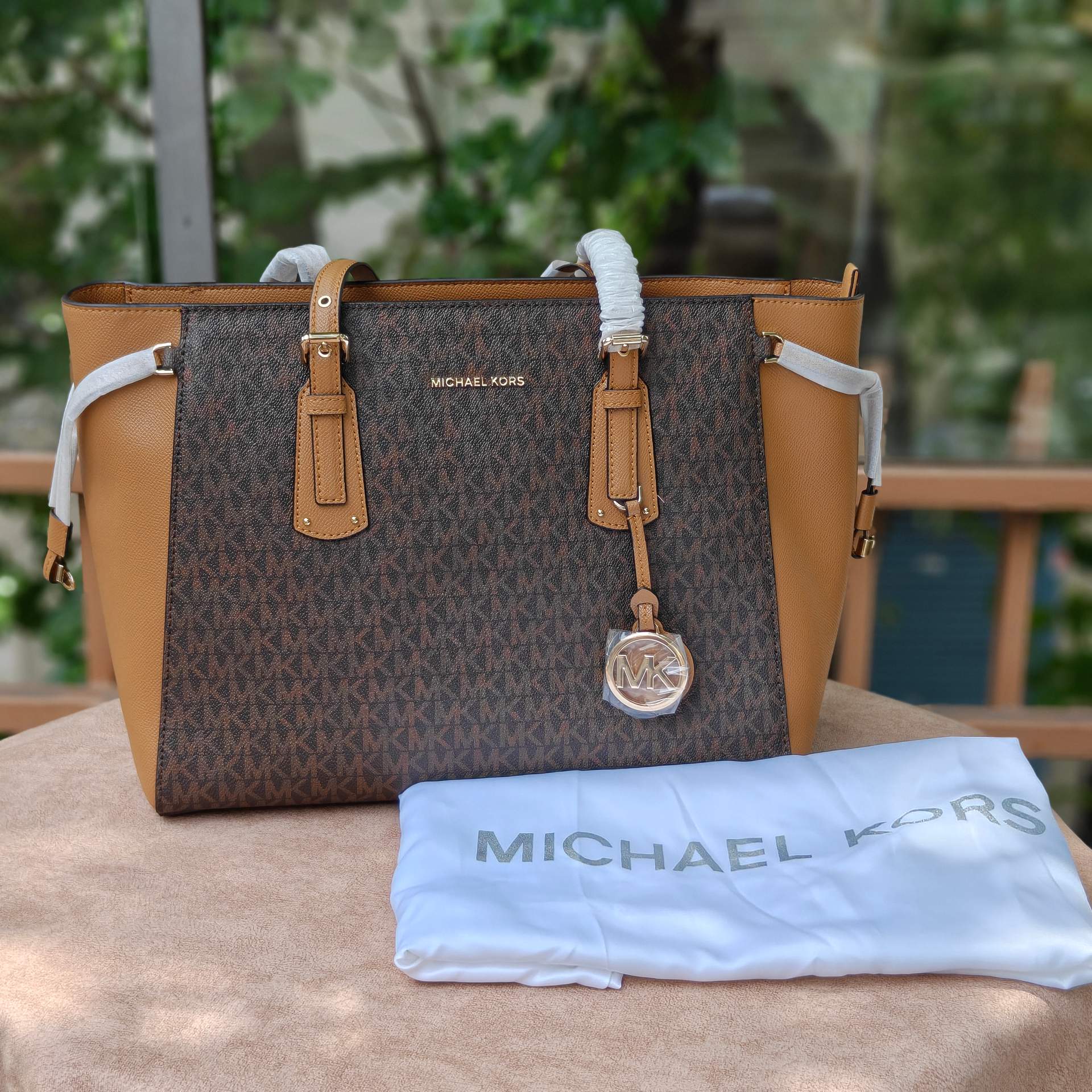 M.K Voyager tote signature monogram print and a gold-tone MK charm